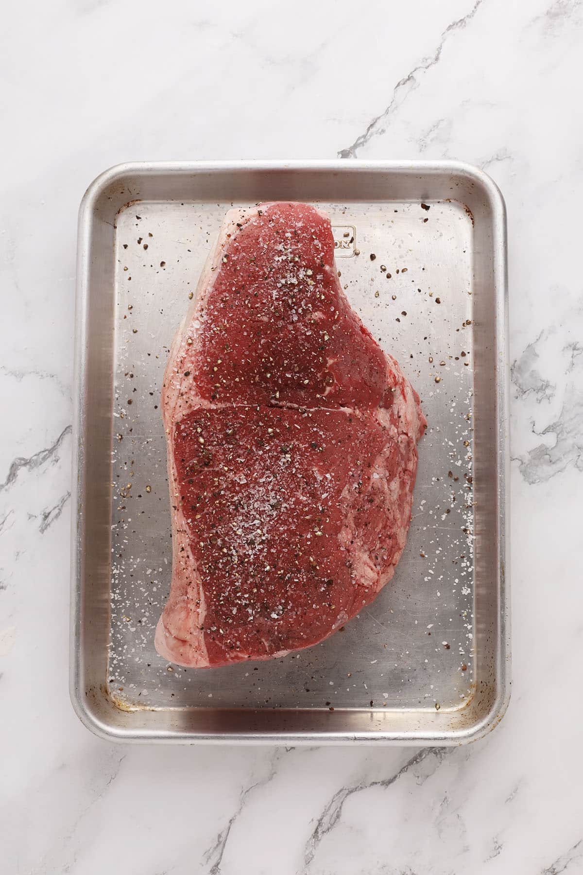 chuck roast that's been seasoned with salt and pepper ready to be seared