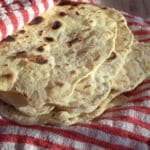 fresh homemade flour tortillas on a towel