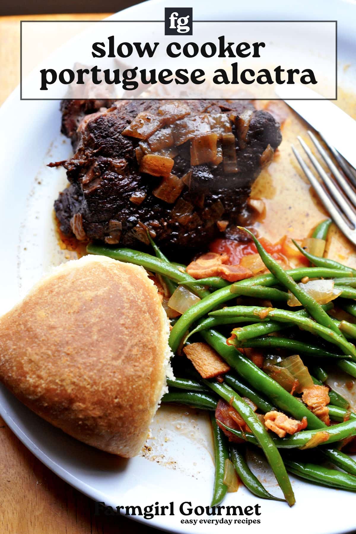 A plate of slow-cooked alcatra Portuguese pot roast with a rich brown sauce, served alongside sautéed green beans and bacon, a tomato slice, and a round bread roll. Text reads: slow cooker portuguese alcatra.