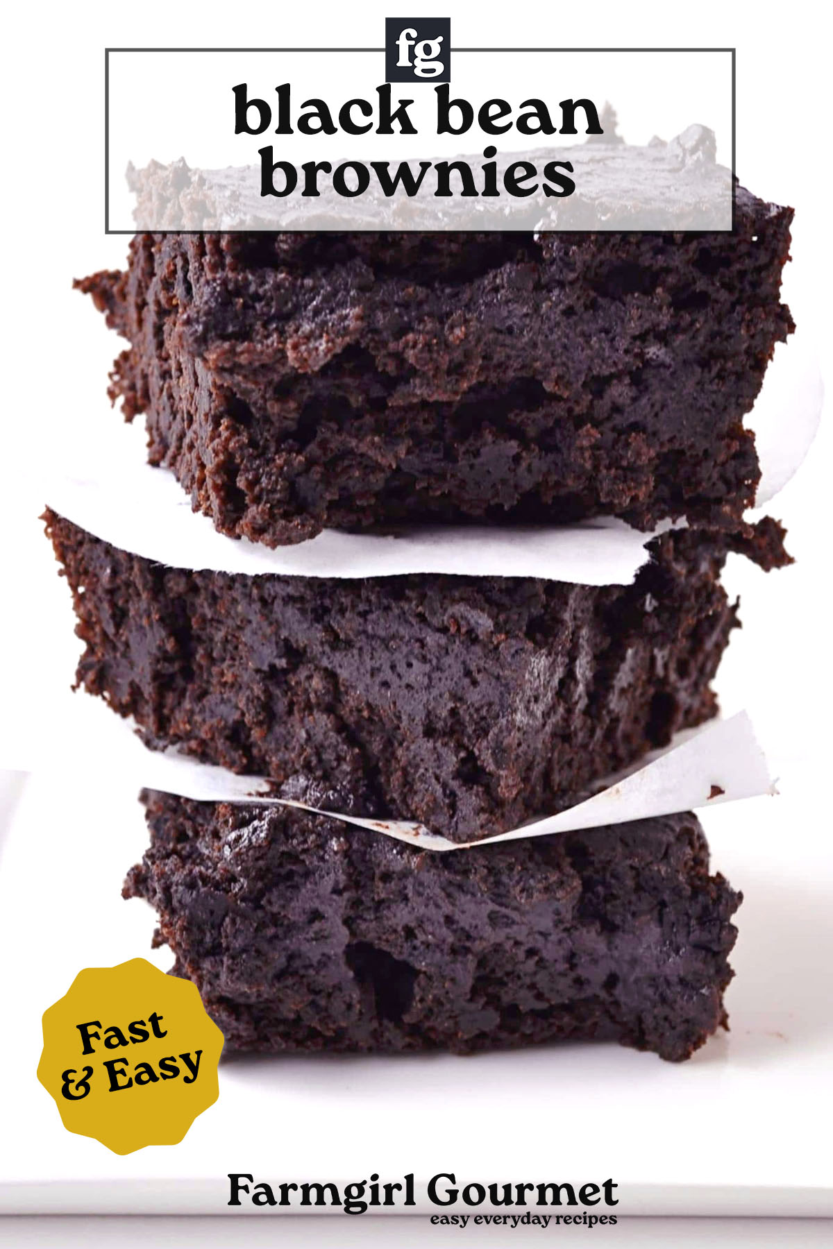 Three thick, fudgy black bean stout brownies are stacked with parchment paper between each piece. The text reads black bean brownies, Fast & Easy, and Farmgirl Gourmet easy everyday recipes.