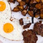 close-up of maple brown sugar breakfast potatoes on a plate with eggs and potatoes