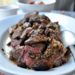 beef roulade stuffed with morels and quinoa on a plate