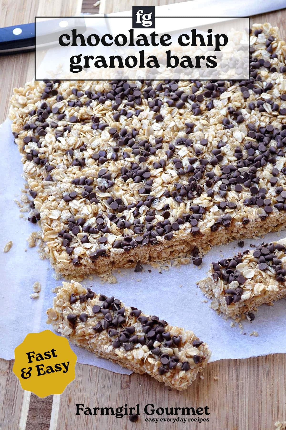 A tray of homemade chewy granola bars on a wooden surface, with one bar cut and pulled out. The bars are topped with mini chocolate chips. Text on the image reads chocolate chip granola bars and Fast & Easy.