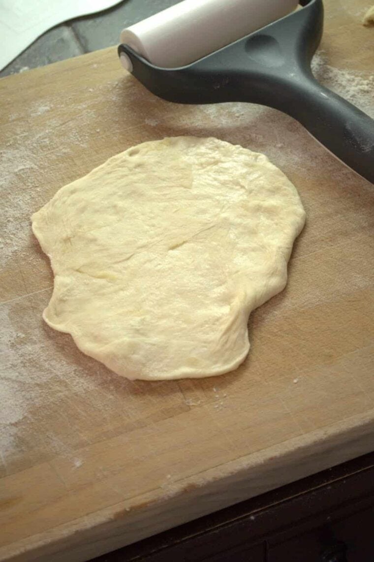 rolling out homemade flour tortillas