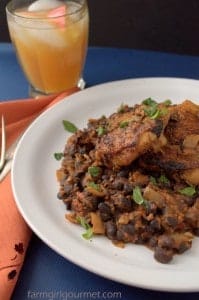 spicy chicken thighs on a bead of chorizo black beans