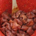 Season cut up pork shoulder with spices and seasonings