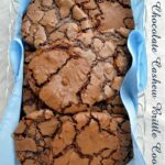 a close up of dark chocolate cashew brittle cookies in a basket