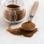 pumpkin pie spice on a spoon with a jar