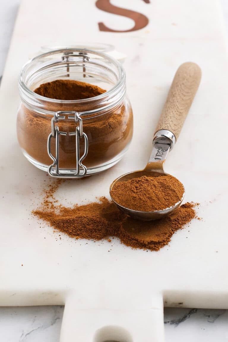 pumpkin pie spice on a spoon with a jar