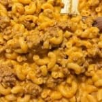 Close-up of creamy homemade hamburger helper, with elbow macaroni coated in cheesy orange sauce and mixed with browned ground beef chunks throughout.