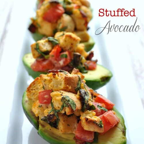close up of blt stuffed avocados on a plate