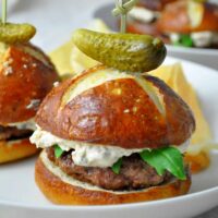 closeup of surf and turf sliders on pretzel buns