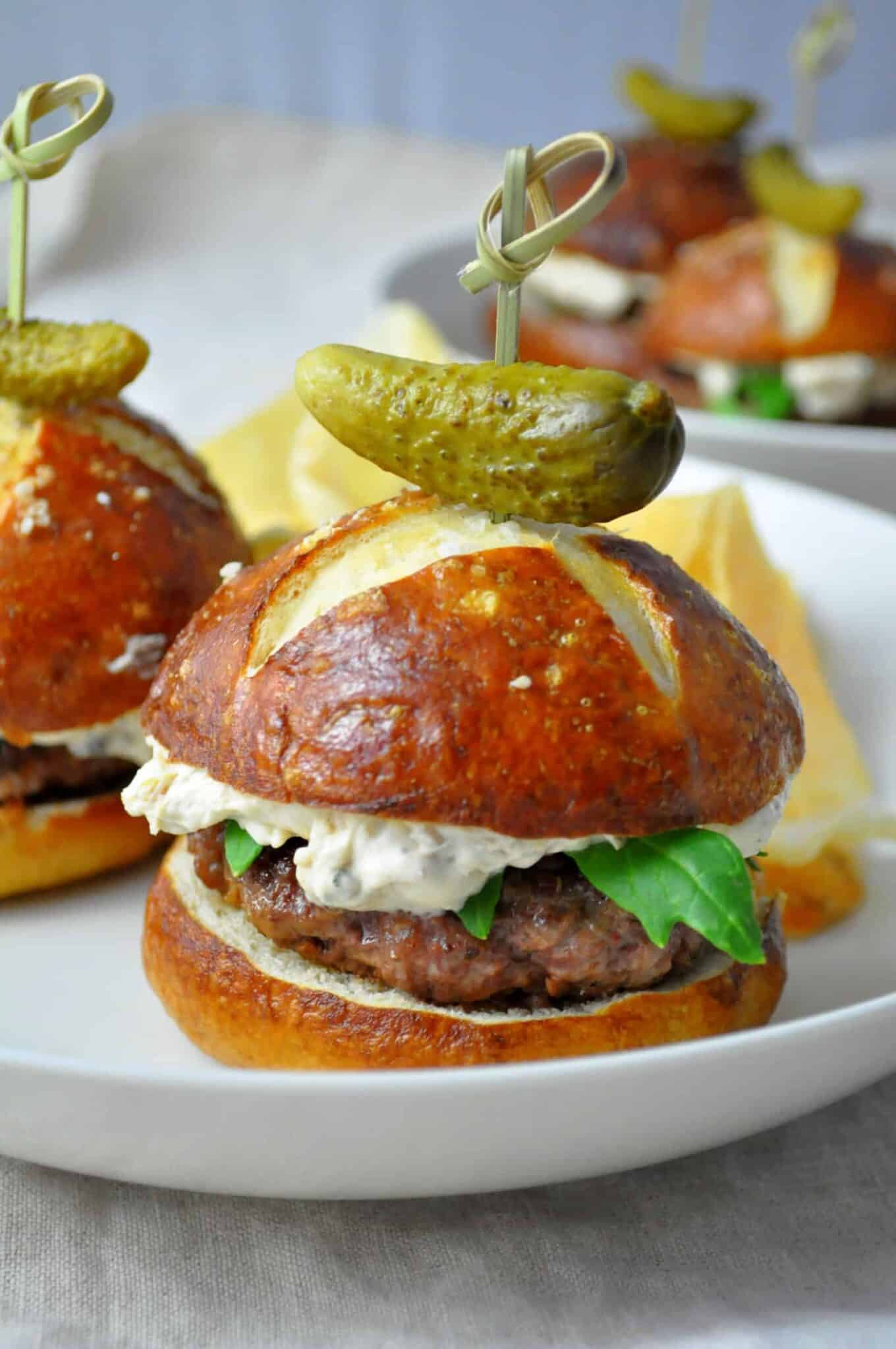 closeup of surf and turf sliders on pretzel buns