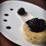 close up of brown butter cake with blackberry sauce