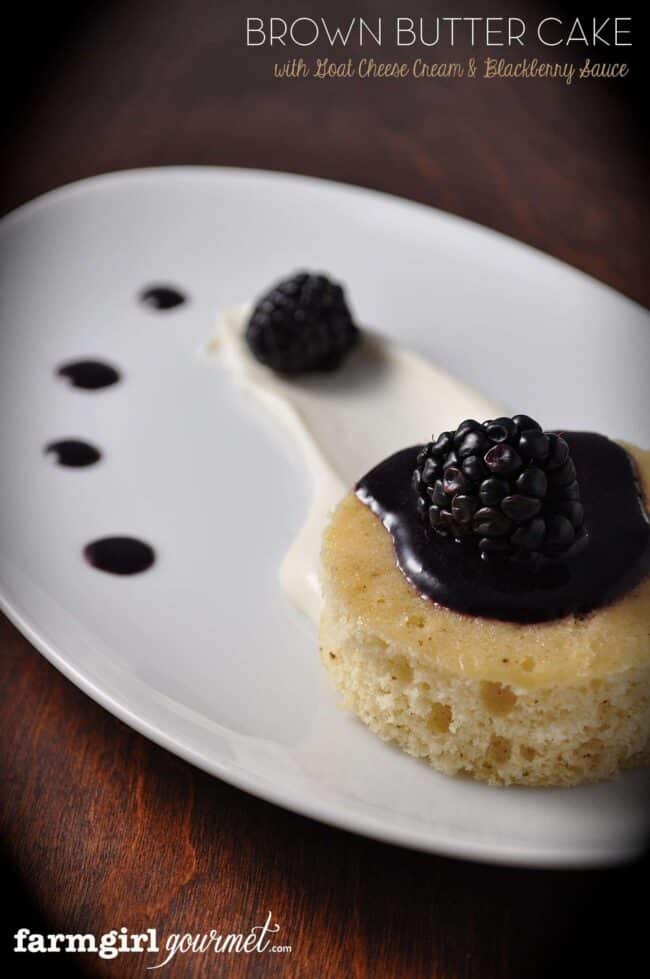 close up of brown butter cake with blackberry sauce