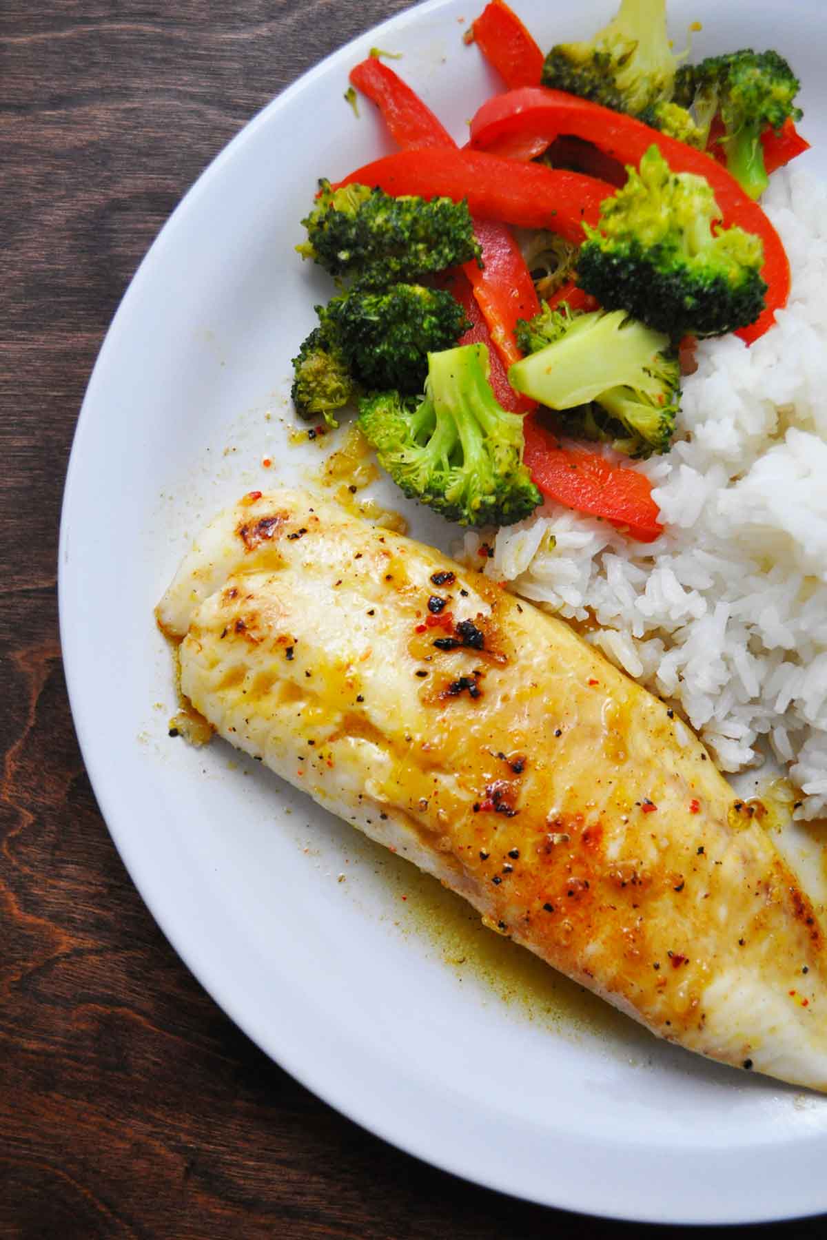 Plated sweet & spicy tilapia with rice and vegetables