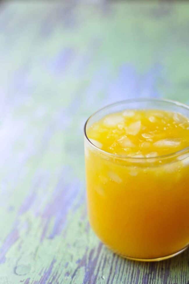 glass of mango orange agua fresca with ice