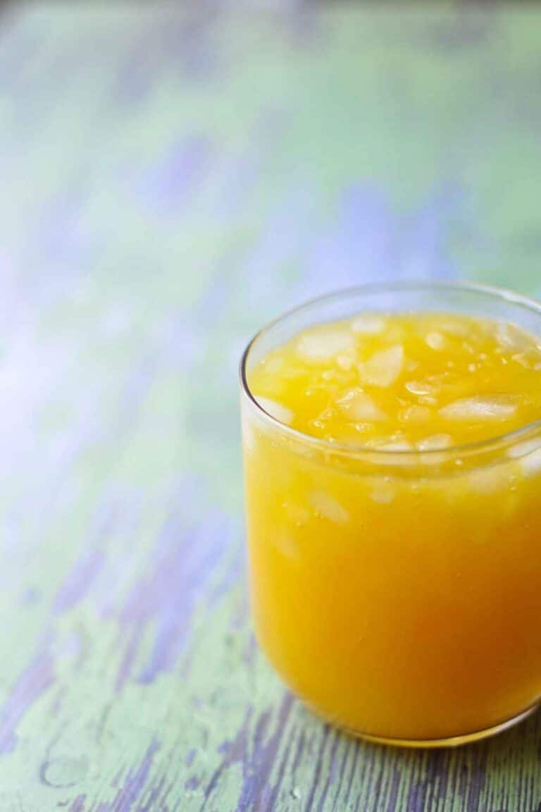 glass of mango orange agua fresca with ice