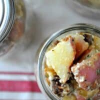warm potato salad with cotija served in a mason jar