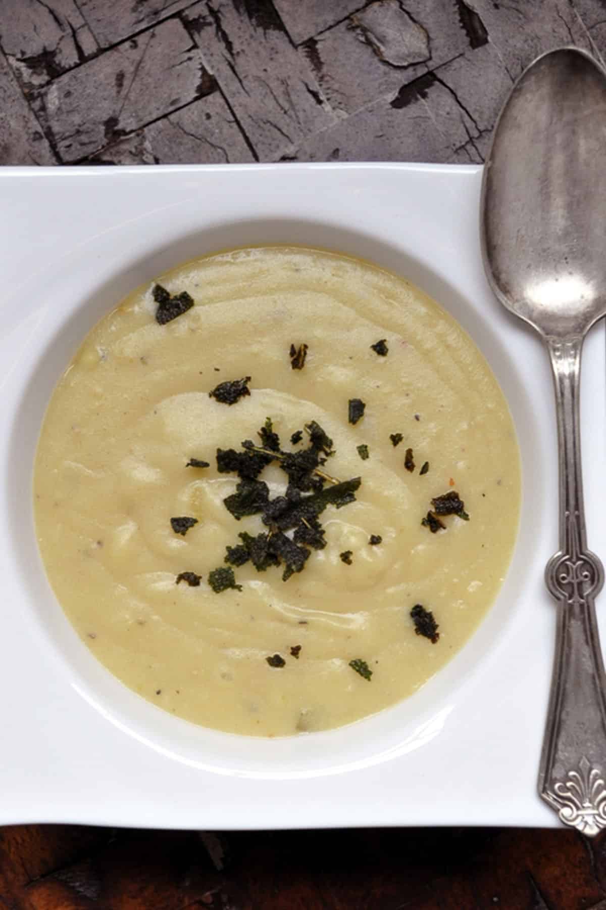 top down image of creamy sweet potato soup with a spoon