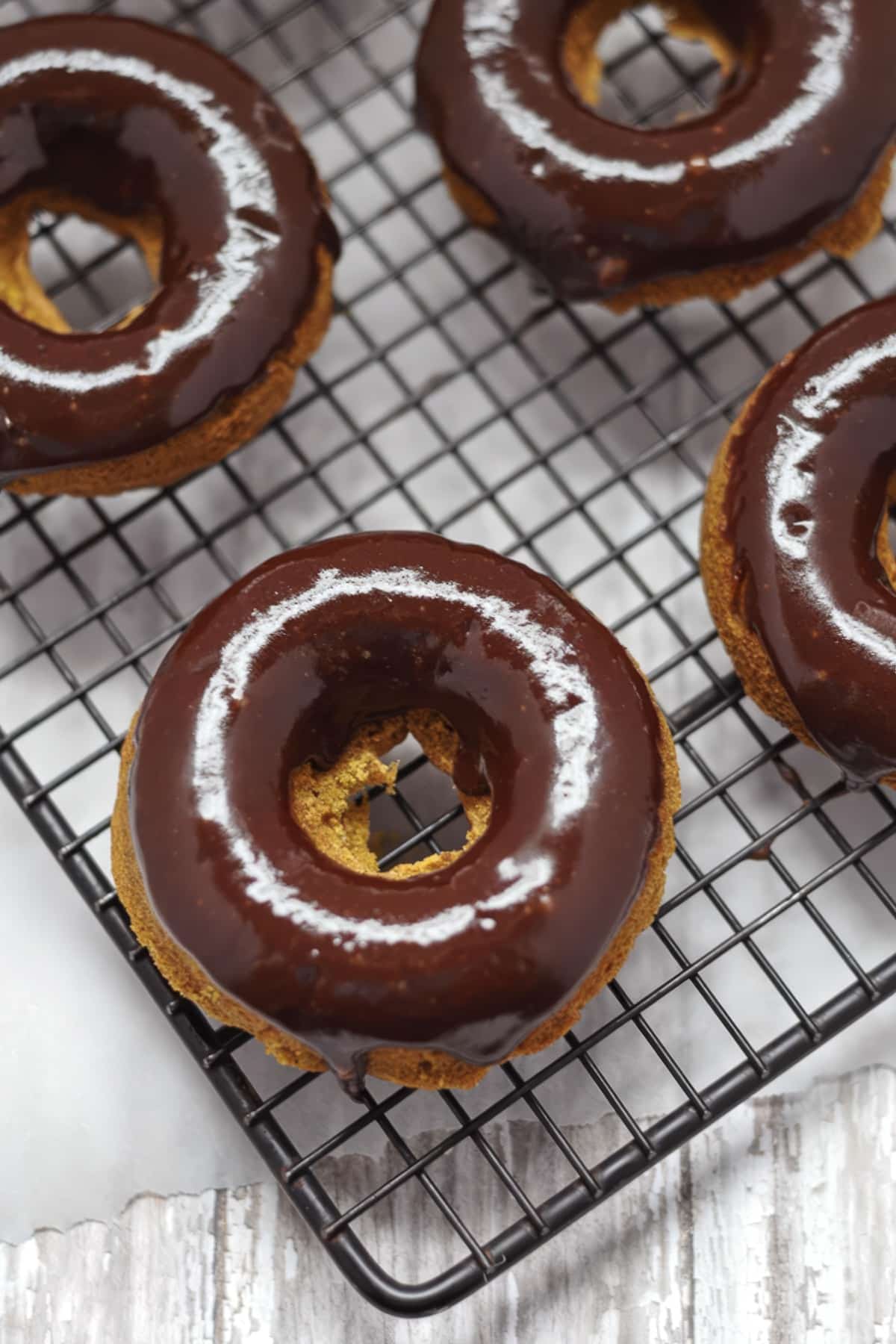 closeup of gluten-free pumpkin donuts with chocolate glaze