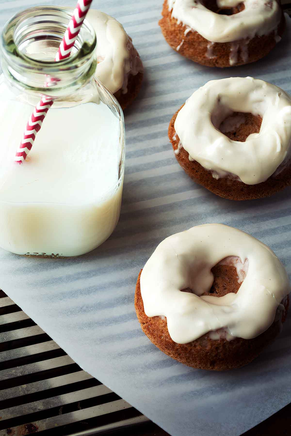 Overhead shot of baked chai donuts with bourbon glaze drizzle