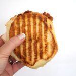 closeup of a turkey bacon and hummus panini