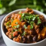 This spicy chorizo sweet potato black bean chili is ready in just 30 minutes and is packed full of hearty deliciousness. Top with cilantro and call it dinner!
