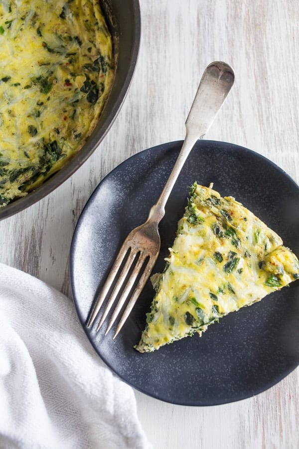 This spinach artichoke frittata is the best breakfast, brunch or dinner! This frittata is packed full of chopped baby spinach, marinated artichokes and sharp Parmesan cheese. The whole dish is ready in less than 30 minutes and crazy delicious!