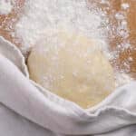 top down of a ball of quick pizza dough on a cutting board
