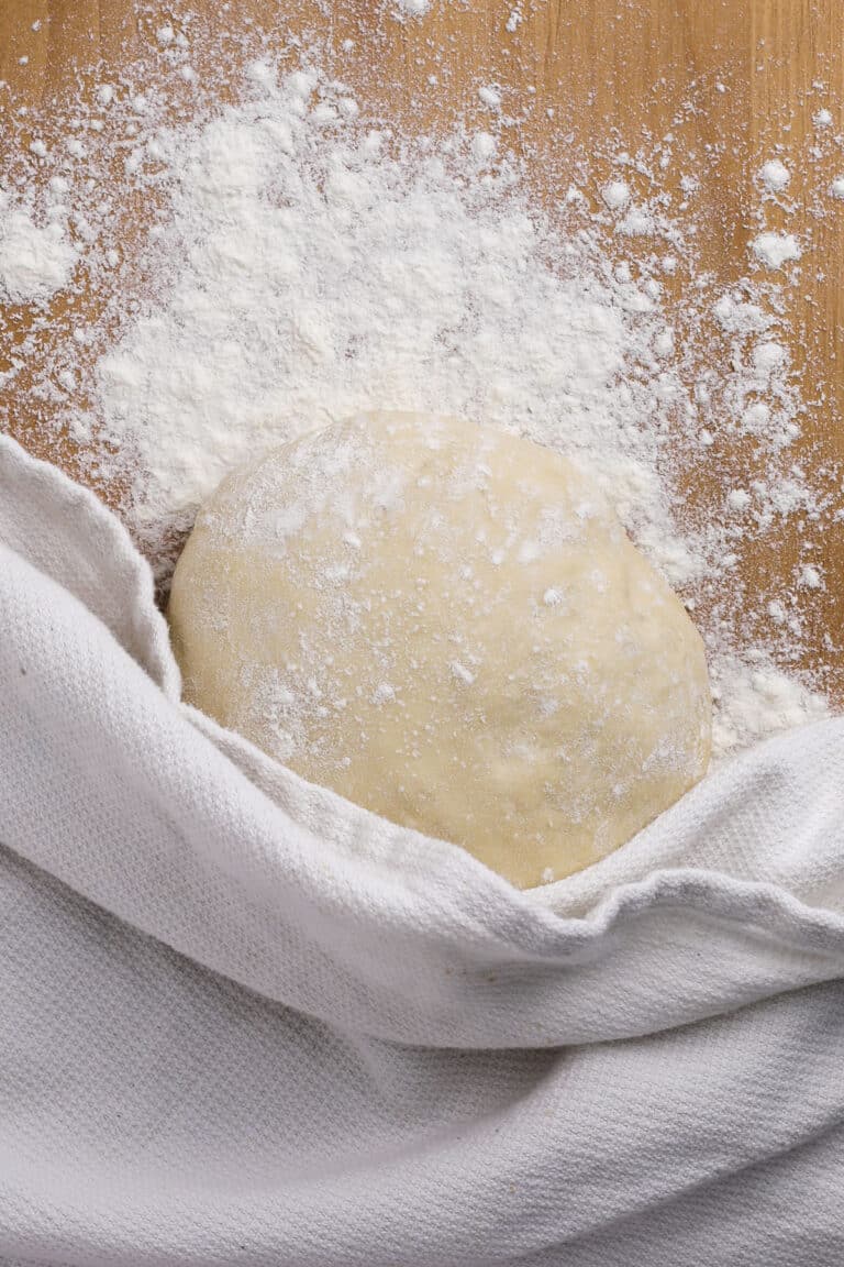 top down of a ball of quick pizza dough on a cutting board