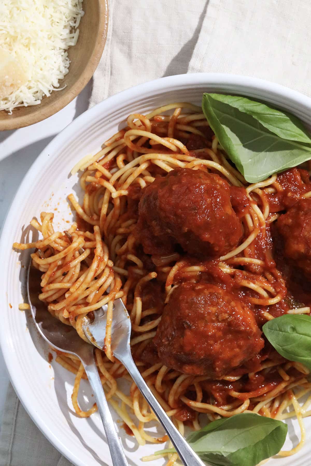 baked italian meatballs on top of spaghetti