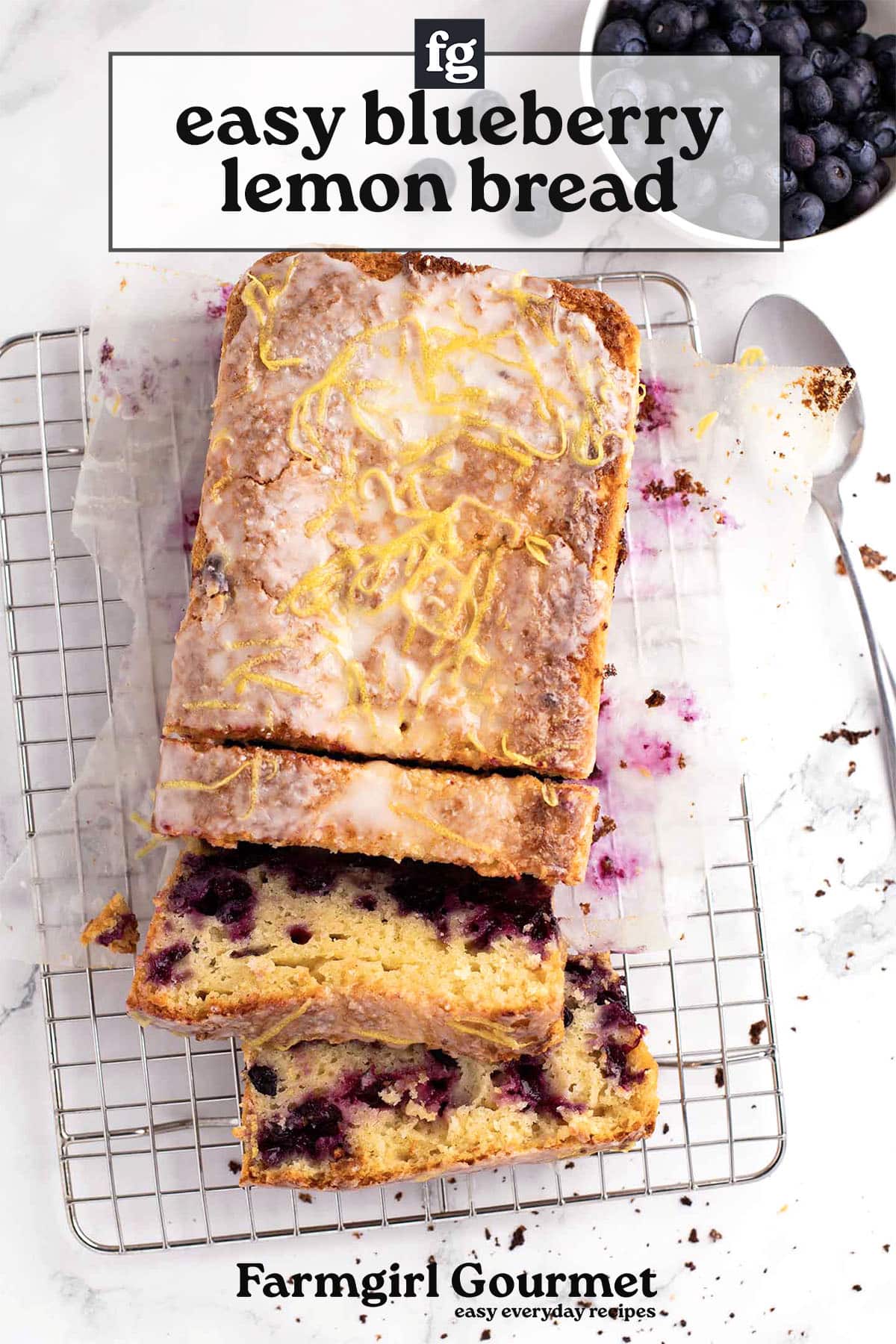 A blueberry lemon loaf with icing and lemon zest sits on parchment atop a cooling rack, several slices cut. A bowl of blueberries is nearby. Text reads “easy blueberry lemon bread” and “Farmgirl Gourmet.”.