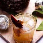 Apple cider cocktail served over ice with citrus and warm spices.