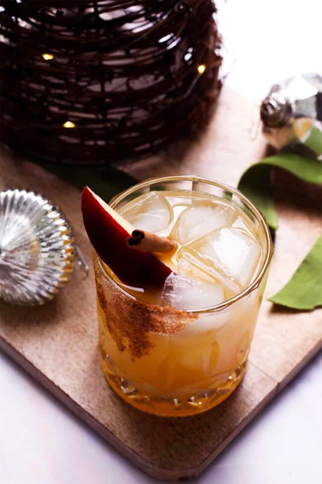 Apple cider cocktail served over ice with citrus and warm spices.