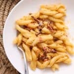 Bowl of creamy Calabrian chile pasta with sundried tomatoes