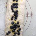 trifolded bread dough with blueberry inclusions