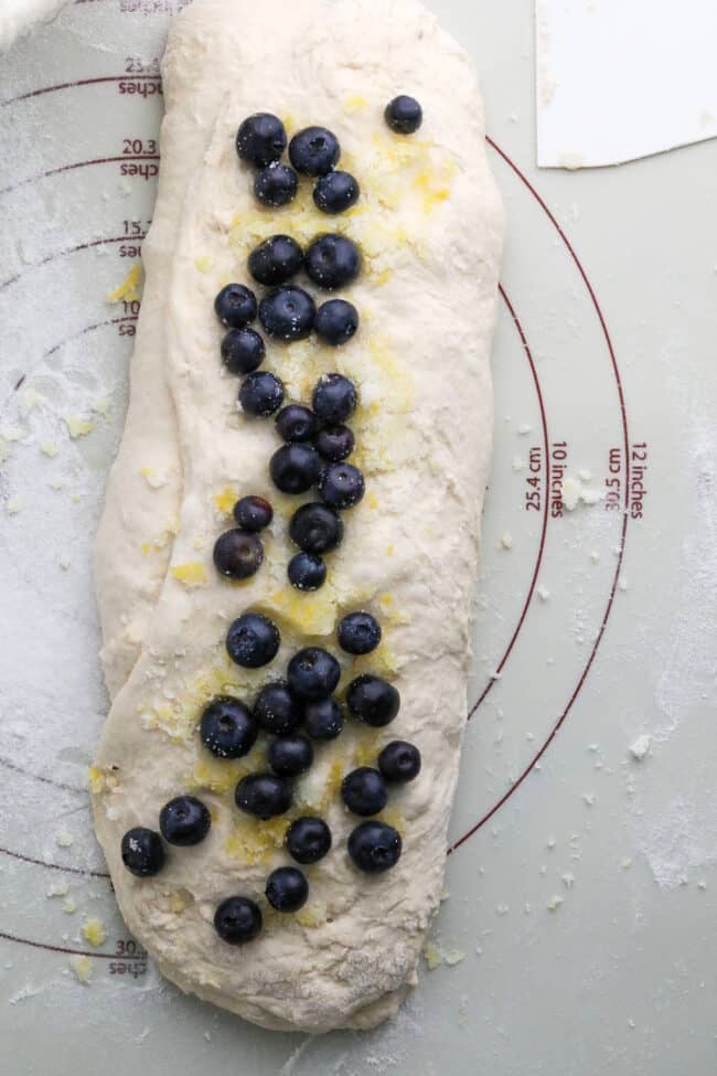 trifolded bread dough with blueberry inclusions