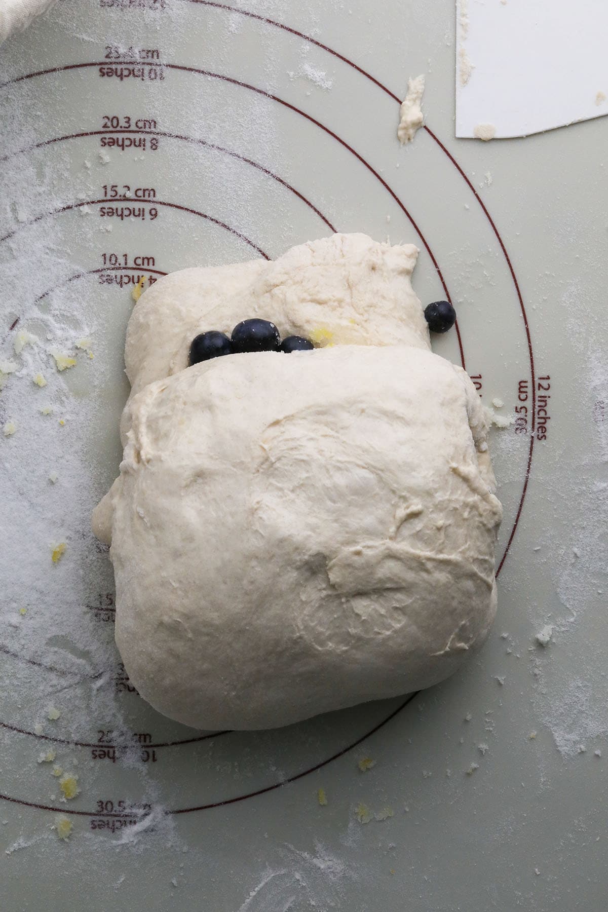 rolling up a blueberry lemon rustic bread
