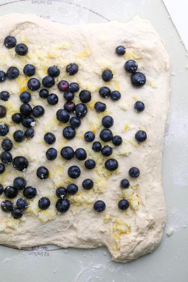 top down view of blueberries and lemon sugar on bread dough