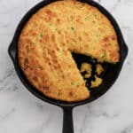 top down view of jalapeno cheddar cornbread in a cast iron skillet