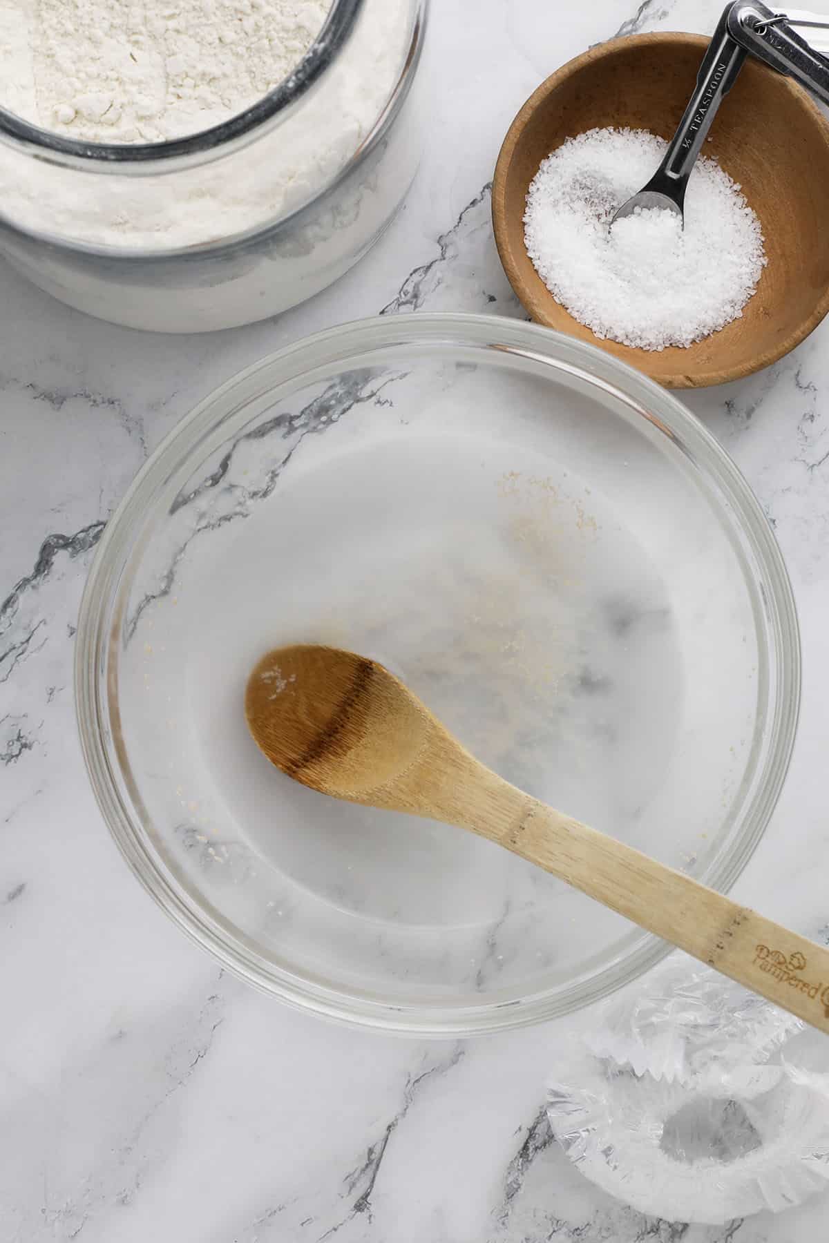 a large bowl with yeast and water