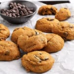 a close up of pumpkin chocolate chip cookies on a tray