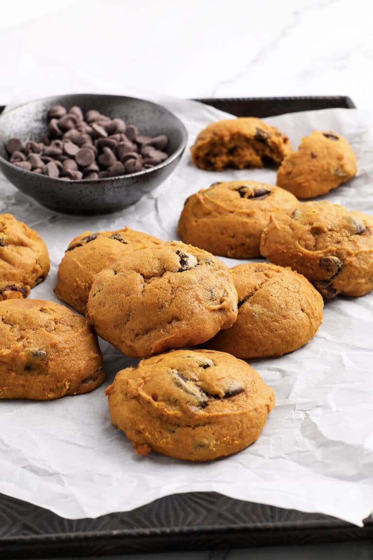 a close up of pumpkin chocolate chip cookies on a tray
