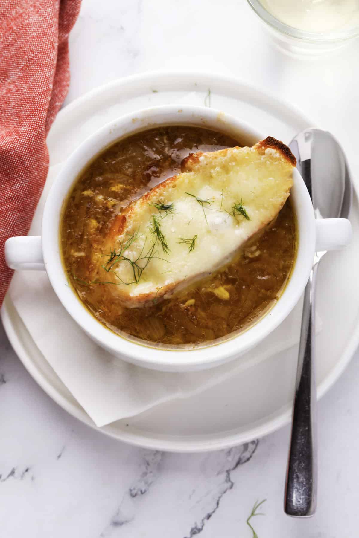 Golden caramelized onions simmering in beef broth