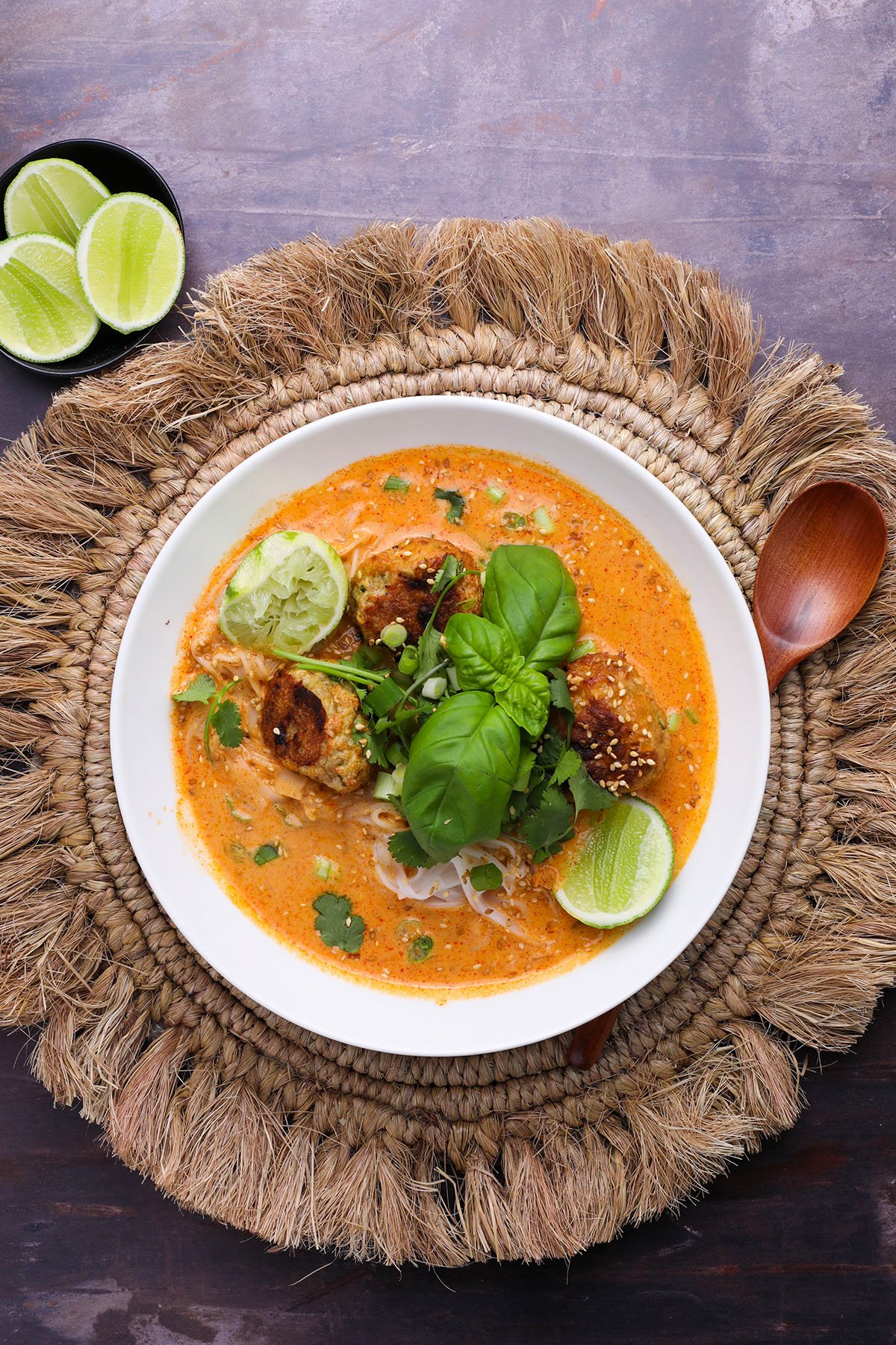 Close-up of creamy Thai-style soup with lime and sesame seeds
