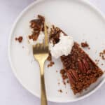 Slice of pecan tart on white plate