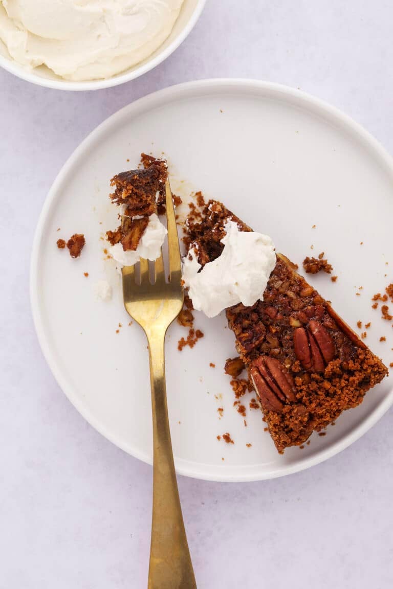 Slice of pecan tart on white plate