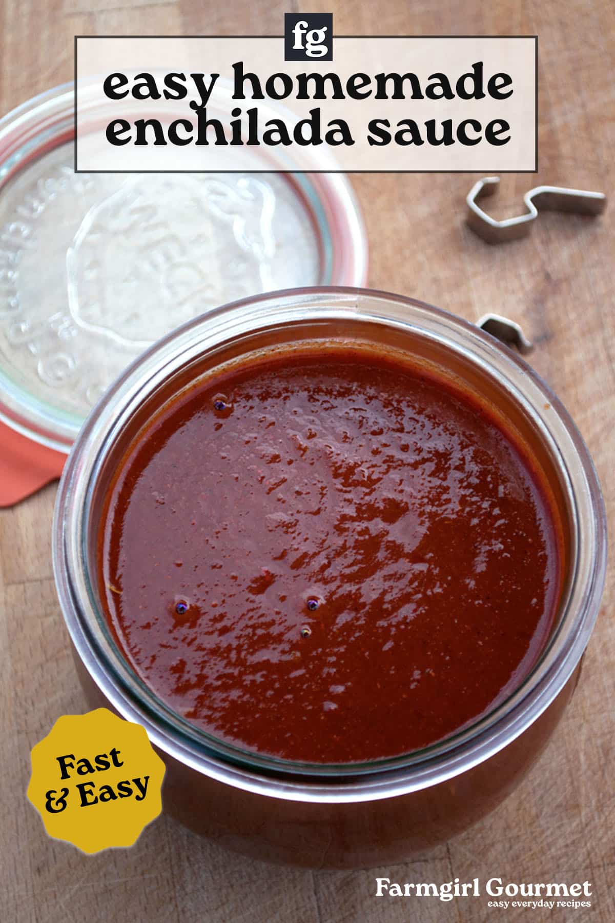 An open glass jar filled with easy homemade enchilada sauce sits on a wooden surface. Text over the image reads “easy homemade enchilada sauce,” “Fast & Easy,” and “Farmgirl Gourmet easy everyday recipes.”.