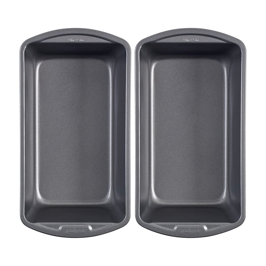 Two identical gray nonstick loaf pans are placed side by side on a white background, viewed from above—an essential image for anyone following the ultimate homemade bread guide.